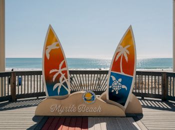 A beach display with two colorful surfboards and the text "Myrtle Beach," set against an ocean backdrop.